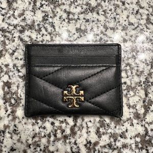 Tory Burch card holder. Black, quilted texture, gold Tory Burch symbol on front.
